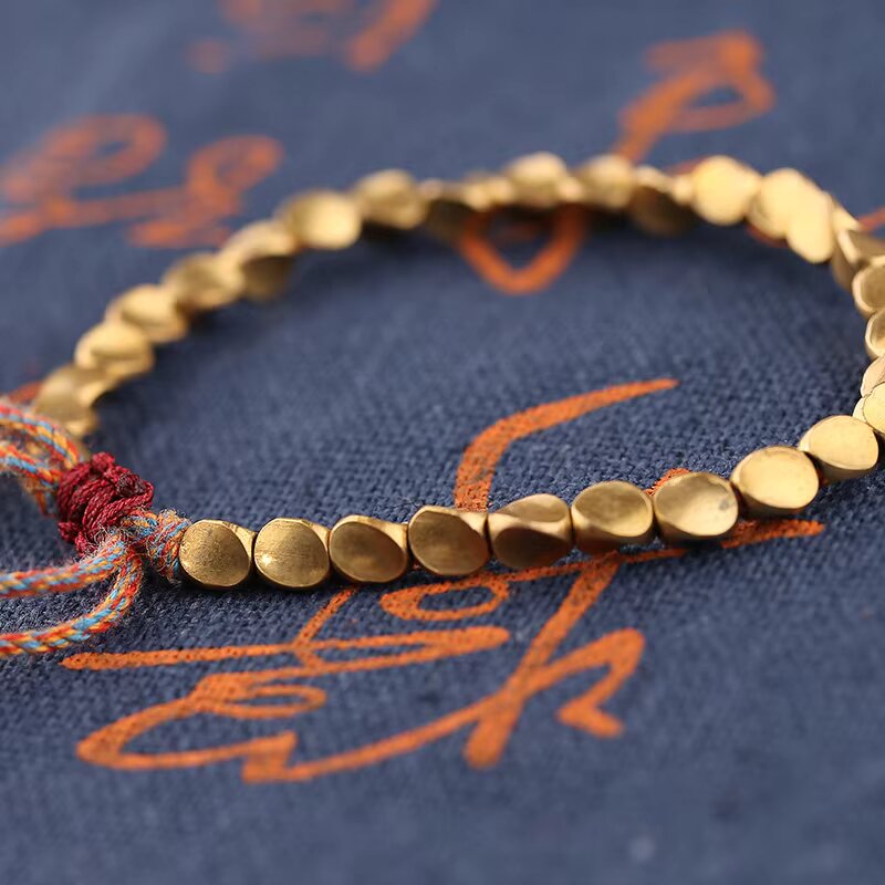 Handcrafted Tibetan Buddhist bracelet with vintage bronze charms